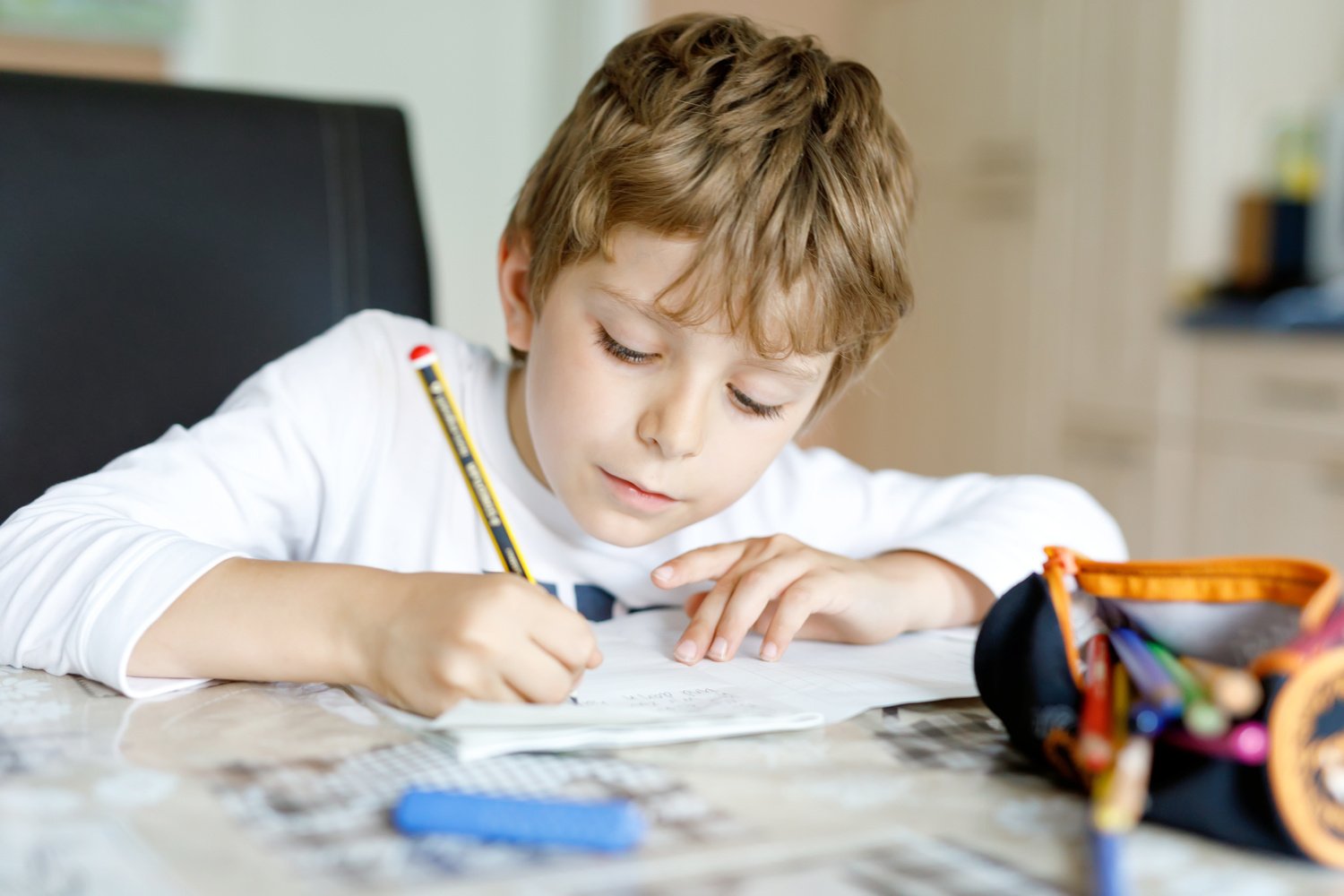 Kid Journal: Elementary school boy circling his feeling forecast for the day in his journal to work through big emotions.  